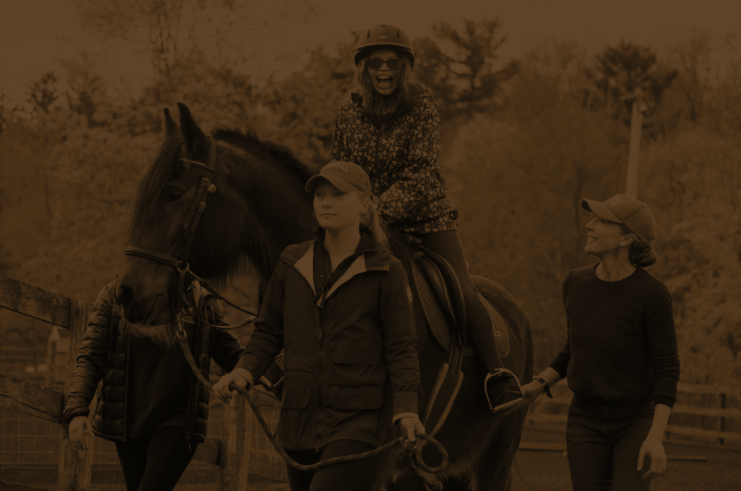 A teen girl riding a horse guided by equine trainers during her therapeutic horsemanship session at Rustic Way Ranch, an equine-assisted psychotherapy center for teens struggling with mental health.